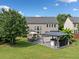 Aerial view of a backyard with patio furniture, a gazebo with a hot tub, and a lush lawn at 3850 Calomel Dr, Cumming, GA 30040