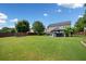 Lush backyard featuring a gazebo, mature trees, and a well-maintained lawn at 3850 Calomel Dr, Cumming, GA 30040