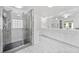 Modern bathroom with a glass shower, marble floors, double sinks, and a large vanity at 3850 Calomel Dr, Cumming, GA 30040