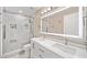 Modern bathroom with double sink vanity, illuminated mirror, and a glass enclosed shower at 3850 Calomel Dr, Cumming, GA 30040