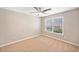 Neutral bedroom with a large window and ceiling fan, offering comfort and natural light at 3850 Calomel Dr, Cumming, GA 30040