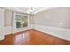Empty dining room featuring hardwood floors, a chandelier, and window with natural light at 3850 Calomel Dr, Cumming, GA 30040