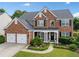 Charming two-story brick home with a well-manicured front yard and two car garage at 3850 Calomel Dr, Cumming, GA 30040