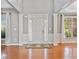 Bright foyer with hardwood floors, columns, and natural light creates an inviting entrance at 3850 Calomel Dr, Cumming, GA 30040