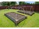 Raised garden beds are ready for planting and protected by arched supports at 3850 Calomel Dr, Cumming, GA 30040
