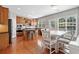 Open kitchen and breakfast nook features hardwood floors, wood cabinets, stainless appliances and granite countertops at 3850 Calomel Dr, Cumming, GA 30040