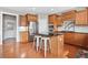 Spacious kitchen with stainless appliances, wooden cabinetry, a kitchen island and hardwood floors at 3850 Calomel Dr, Cumming, GA 30040