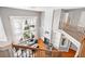 View from the top of the staircase overlooking the living room with fireplace and two-story windows at 3850 Calomel Dr, Cumming, GA 30040