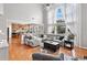 Bright living room boasts hardwood floors, a modern ceiling fan and two-story windows with sheer curtains at 3850 Calomel Dr, Cumming, GA 30040