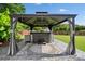 Beautiful backyard patio features a hot tub under a stylish gazebo with curtains at 3850 Calomel Dr, Cumming, GA 30040