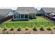 Fenced backyard with a screened-in porch, green lawn, and professionally landscaped garden beds at 4160 Grandview Vista St, Cumming, GA 30028