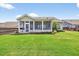 Expansive backyard featuring a well-maintained lawn and a covered patio at 4160 Grandview Vista St, Cumming, GA 30028