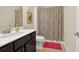 Neutral bathroom offers white countertops, dark wood cabinets, and vanity mirror at 4160 Grandview Vista St, Cumming, GA 30028