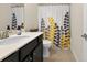 Bathroom features a modern vanity and shower with decorative curtain at 4160 Grandview Vista St, Cumming, GA 30028