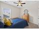 Bedroom with a ceiling fan, window, and a well made bed at 4160 Grandview Vista St, Cumming, GA 30028