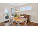 Bright dining area features a wooden table set, chandelier, and a view to the outdoor patio at 4160 Grandview Vista St, Cumming, GA 30028