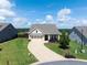 Inviting single-Gathering home featuring a manicured lawn, three-car garage, and charming front porch at 4160 Grandview Vista St, Cumming, GA 30028