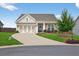 Inviting home featuring a two-car garage, well-maintained lawn, and a cozy front porch, perfect for relaxation at 4160 Grandview Vista St, Cumming, GA 30028