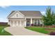 Charming single Gathering home featuring a two-car garage, manicured lawn and cozy front porch with rocking chairs at 4160 Grandview Vista St, Cumming, GA 30028