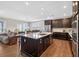 Spacious kitchen features dark cabinets, stainless steel appliances, and center island with seating at 4160 Grandview Vista St, Cumming, GA 30028