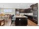 Modern kitchen with dark cabinets, stainless steel appliances, granite countertops, and a central island at 4160 Grandview Vista St, Cumming, GA 30028
