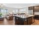 Spacious kitchen island featuring granite countertops, stainless steel appliances and dark wood cabinets at 4160 Grandview Vista St, Cumming, GA 30028
