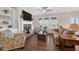 Spacious living room boasts hardwood floors, a fireplace with built-in shelves, and large windows offering stunning views and natural light at 4160 Grandview Vista St, Cumming, GA 30028