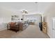 Spacious living room with plush carpet, ceiling fan, and large windows at 4160 Grandview Vista St, Cumming, GA 30028