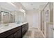 Bathroom featuring double sinks, granite counters, a glass-enclosed shower, and neutral tile flooring at 4160 Grandview Vista St, Cumming, GA 30028