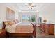 Bright main bedroom featuring hardwood floors, tray ceiling, and a serene view at 4160 Grandview Vista St, Cumming, GA 30028