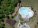 Aerial view of a community pool, playground and recreation area surrounded by trees and lush landscaping at 4160 Grandview Vista St, Cumming, GA 30028