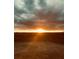 A beautiful sunset lights up the horizon as seen from the home's backyard, creating an awe-inspiring atmosphere at 4160 Grandview Vista St, Cumming, GA 30028