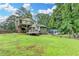 Expansive backyard featuring a deck, patio, and lush green lawn at 4444 Lisa Nw Way, Lilburn, GA 30047