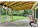 Covered deck area opening to a spacious yard with green grass and mature trees at 4444 Lisa Nw Way, Lilburn, GA 30047