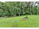 Large, well-maintained backyard with vibrant green grass and mature trees at 4444 Lisa Nw Way, Lilburn, GA 30047