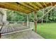 Backyard view from the deck with a lush lawn and wooded surroundings at 4444 Lisa Nw Way, Lilburn, GA 30047