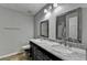 Modern bathroom featuring dual sinks, marble countertops, and framed mirrors at 4444 Lisa Nw Way, Lilburn, GA 30047