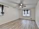 Bright bedroom featuring stylish floors, a ceiling fan, and well-lit windows at 4444 Lisa Nw Way, Lilburn, GA 30047