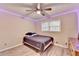Comfortable bedroom featuring wood floors, a ceiling fan, and a large window at 4444 Lisa Nw Way, Lilburn, GA 30047