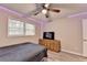 Comfortable bedroom featuring wood floors, a ceiling fan, and a wooden dresser at 4444 Lisa Nw Way, Lilburn, GA 30047