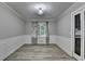 Dining room featuring decorative molding, neutral paint and luxury vinyl plank flooring at 4444 Lisa Nw Way, Lilburn, GA 30047