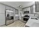 Modern kitchen featuring grey cabinets, stainless steel appliances, and quartz countertops at 4444 Lisa Nw Way, Lilburn, GA 30047