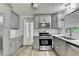 Modern kitchen featuring grey cabinets, stainless steel appliances, and quartz countertops at 4444 Lisa Nw Way, Lilburn, GA 30047