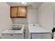 Convenient laundry room featuring wood cabinets, Maytag washer and Samsung dryer at 4444 Lisa Nw Way, Lilburn, GA 30047