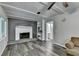 Bright living room featuring a gray brick fireplace, white built-in shelves, and wood floors at 4444 Lisa Nw Way, Lilburn, GA 30047