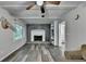 Inviting living room with a gray brick fireplace, white built-in shelves, and wood floors at 4444 Lisa Nw Way, Lilburn, GA 30047