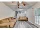 Spacious living room featuring wood floors, couches, and a french door to the backyard at 4444 Lisa Nw Way, Lilburn, GA 30047