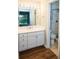 Bright bathroom with white vanity, decorative mirror, and tiled shower at 591 Emory Oaks Way # 591, Decatur, GA 30033