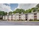 Well-maintained apartment building with manicured landscaping and charming architectural details at 591 Emory Oaks Way # 591, Decatur, GA 30033