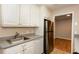 Kitchen with white cabinets, gray counters, stainless steel appliances, and wood flooring in adjacent room at 591 Emory Oaks Way # 591, Decatur, GA 30033
